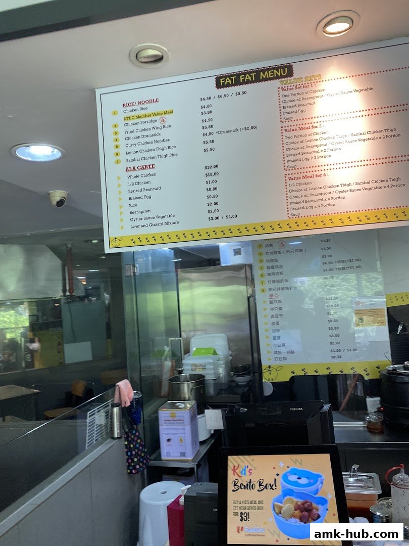 A menu board displaying various rice, noodle, and ala carte dishes with prices.