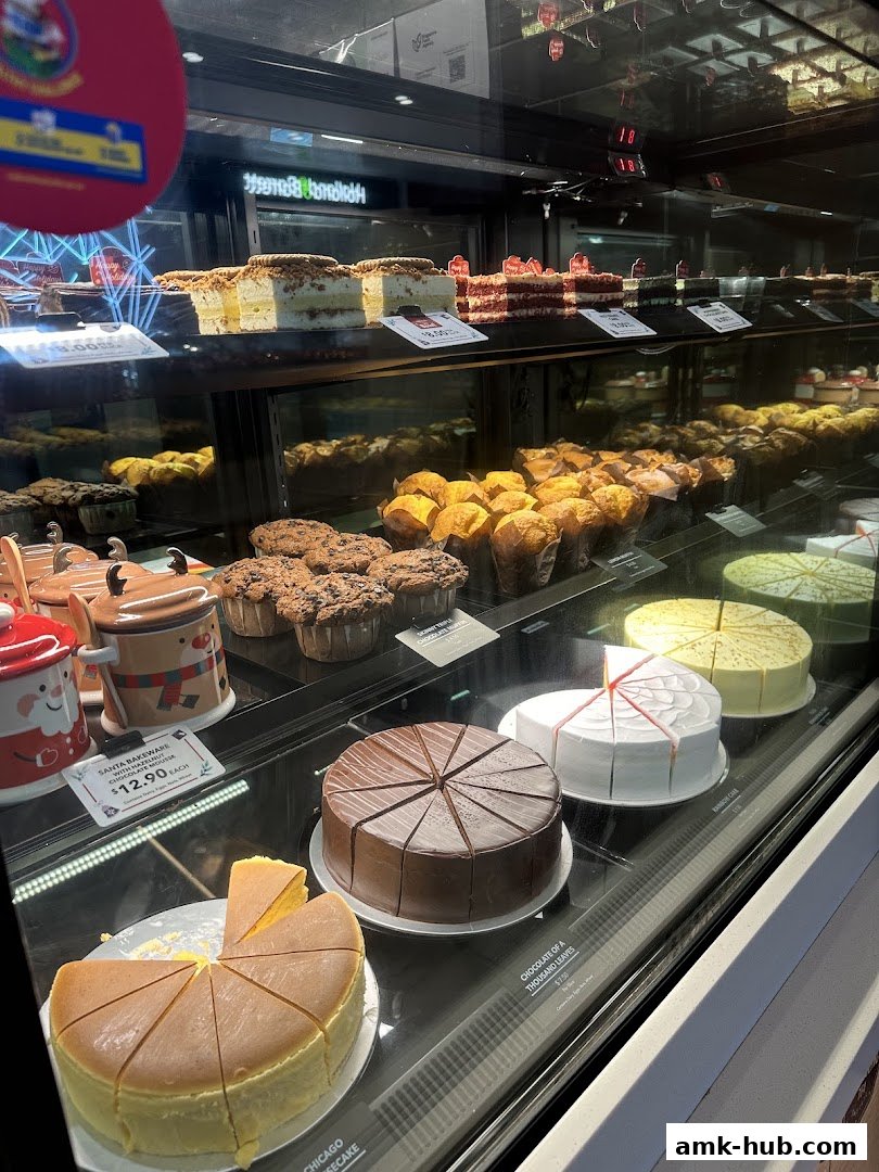 A display case filled with various cakes, muffins, and pastries at The Coffee Bean and Tea Leaf.