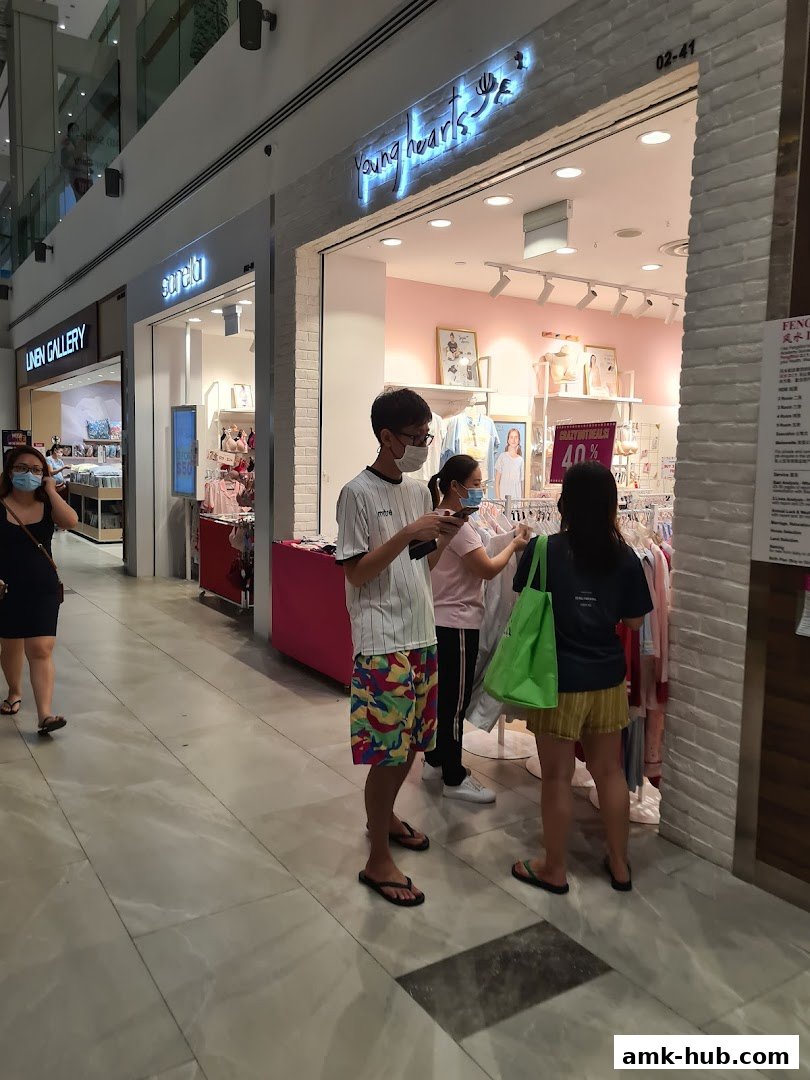 People browsing clothes outside the Young Hearts store at AMK Hub.