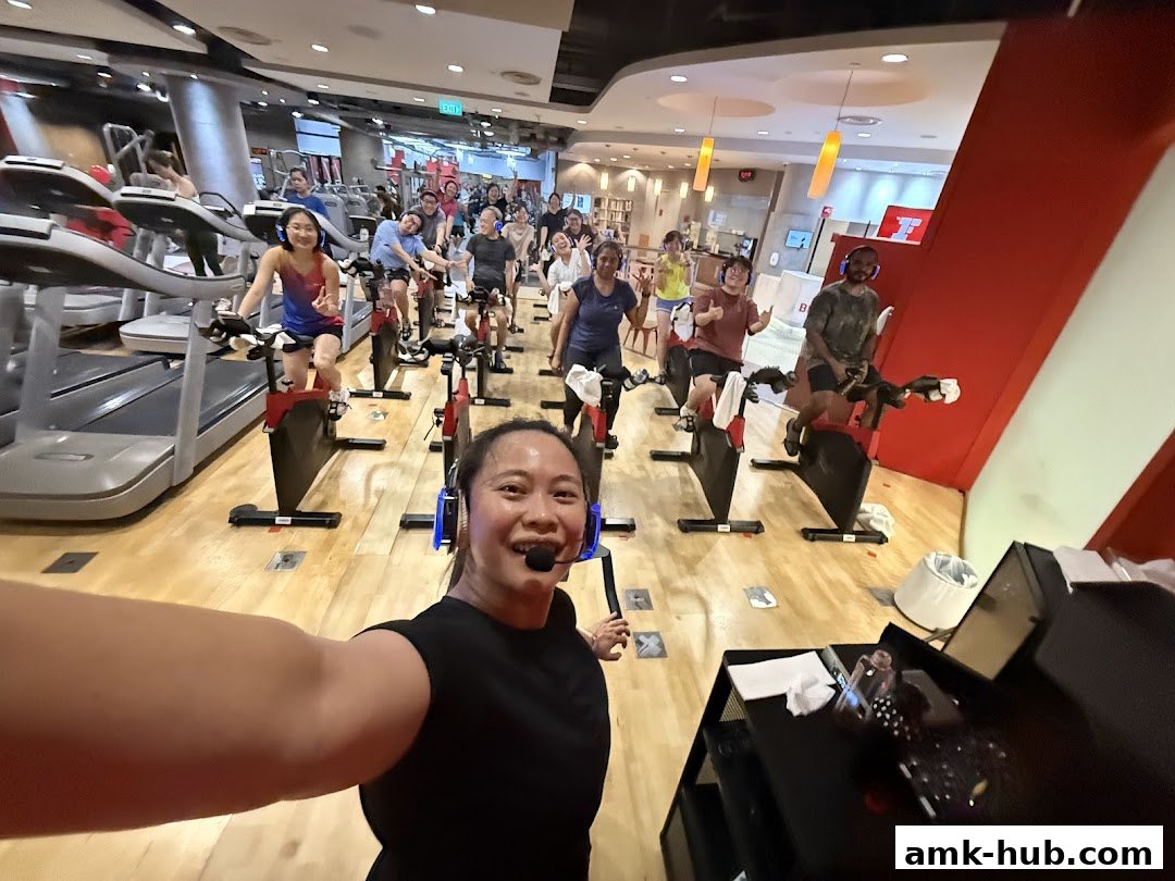 A group of people participating in a spin class at Fitness First.
