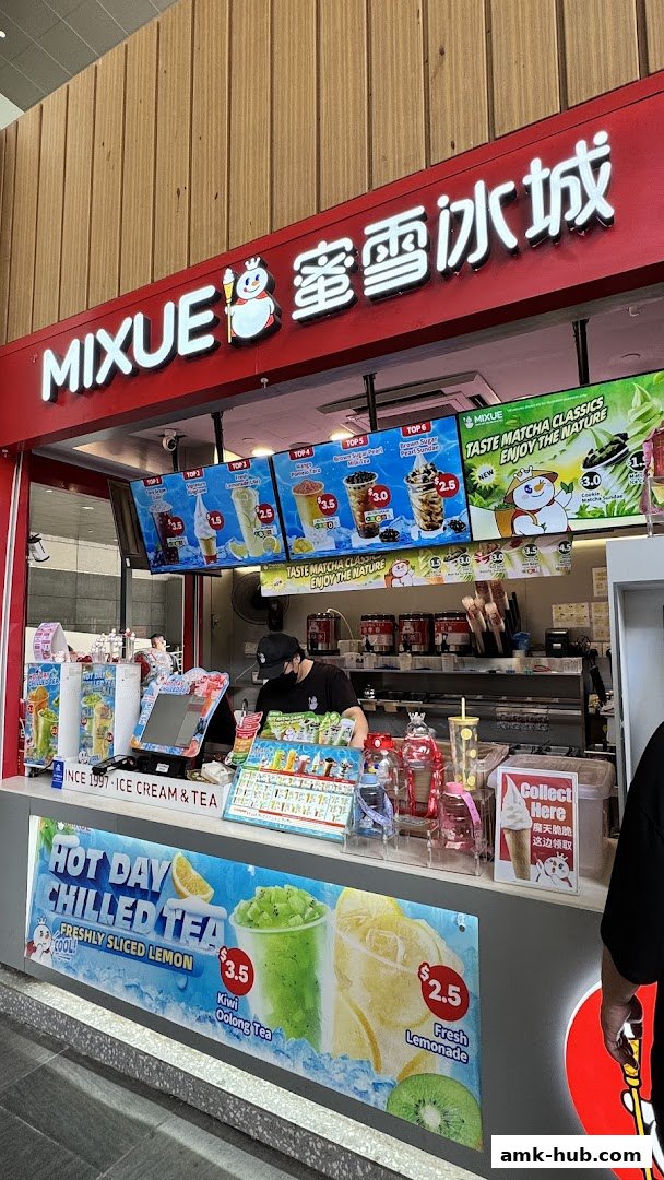 A Mixue ice cream and tea shop with digital menus displaying drinks and prices.