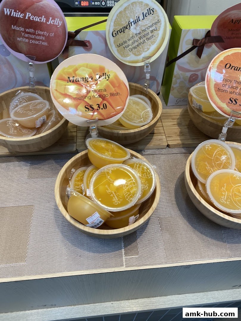A display of assorted fruit jellies, including mango, grapefruit, and white peach flavors.