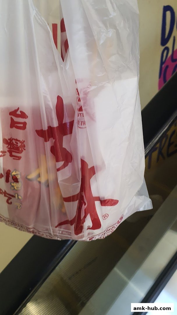 A white plastic bag with red Chinese characters and a logo from Shihlin Taiwan Street Snacks.