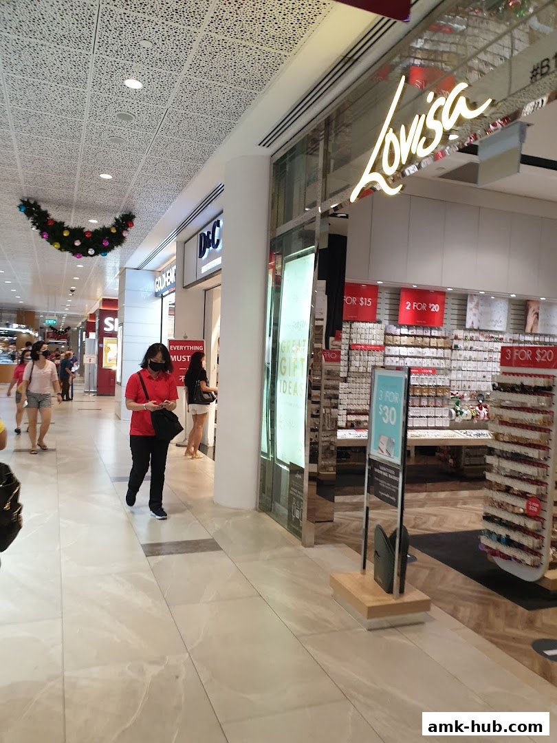 A shopping mall corridor with several shops, including Lovisa and D&C, with promotional signs.