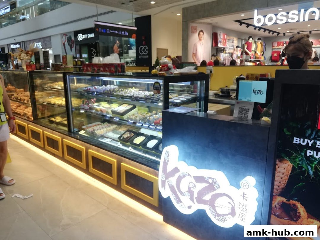 A Kazo shop display case filled with pastries and desserts, with a counter and signage.