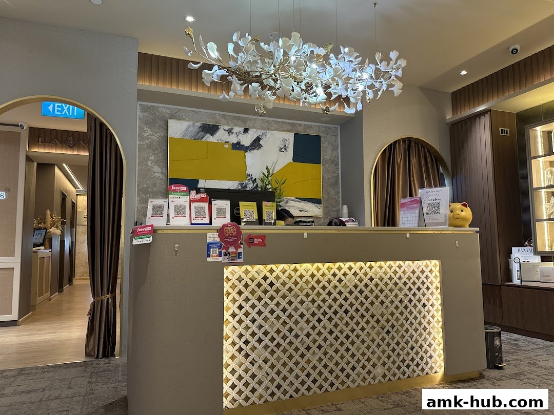 The reception area of a beauty salon with a modern chandelier and artwork.