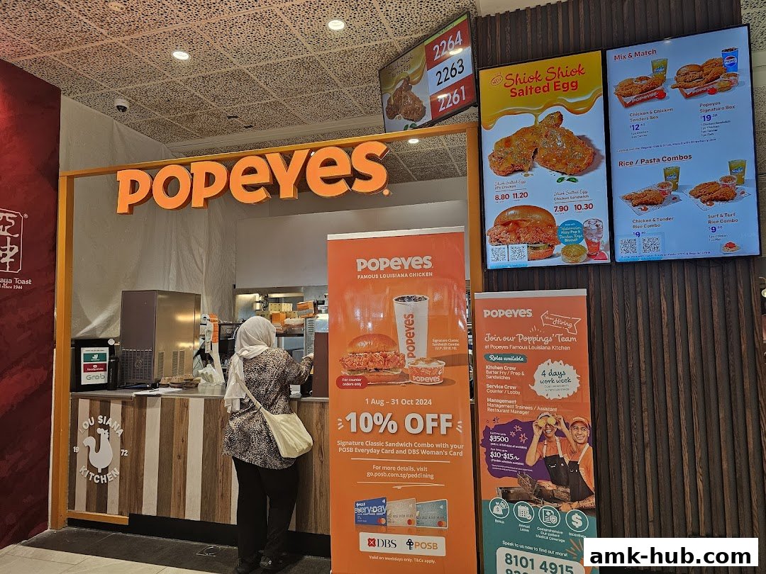 Popeyes restaurant with menu boards displaying fried chicken and combo meals.