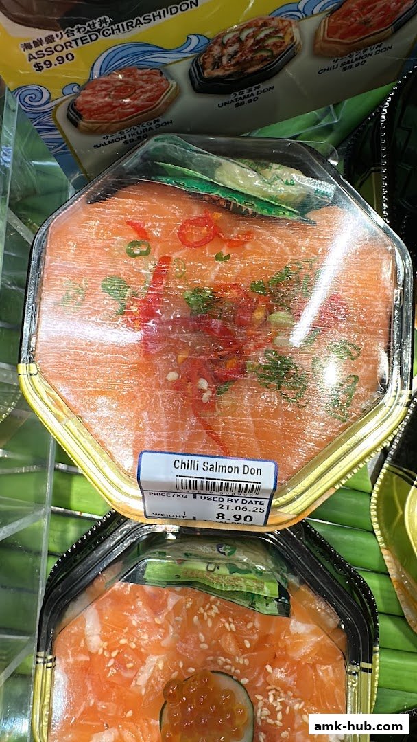 Close-up of a packaged Chilli Salmon Don with fresh salmon and chili slices.