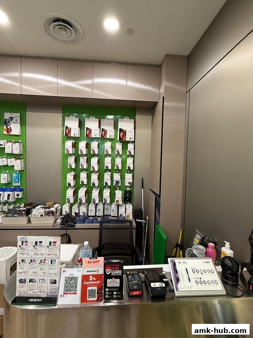Interior view of a retail shop counter with mobile accessories and payment terminals.