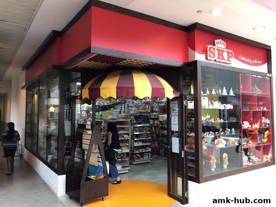 The exterior of a brightly lit SKP shop with a wide selection of party supplies and toys.