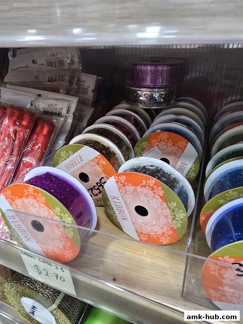 A display of various colorful ribbons and craft supplies on shelves.