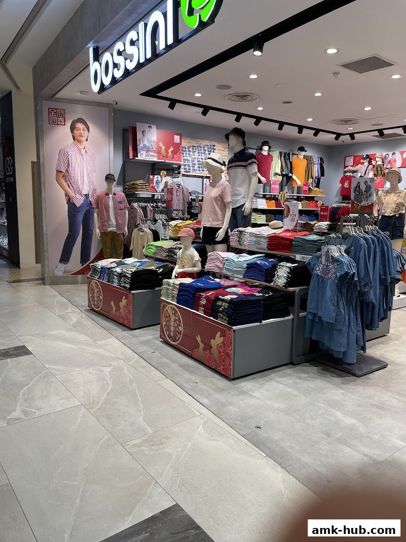 Bossini store interior showcasing colorful t-shirts and apparel on display with mannequins.