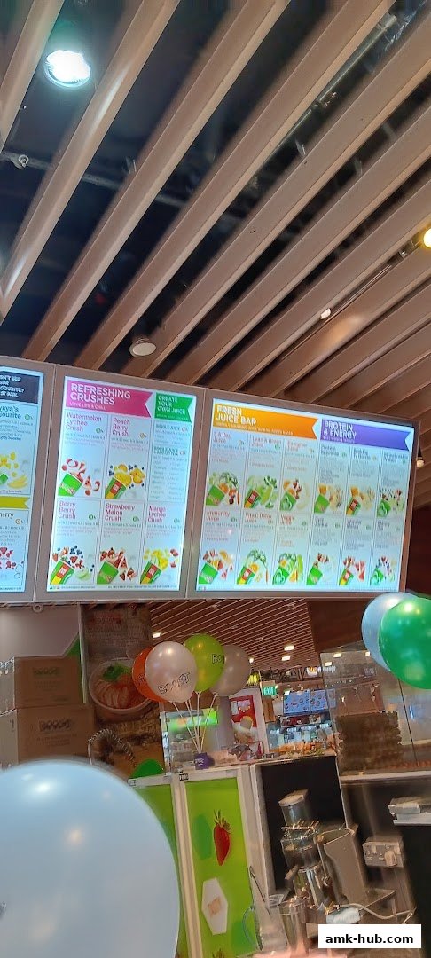 A brightly lit menu board displaying various juice and smoothie options at Boost Juice.