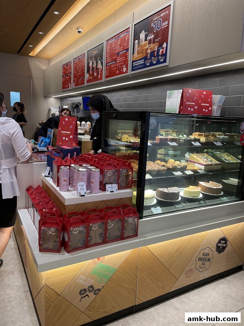 Interior view of The Coffee Bean and Tea Leaf shop with display of cakes and gift boxes.