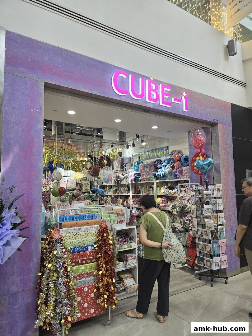 A CUBE-i shop front displaying a variety of party supplies, gifts, and stationery.