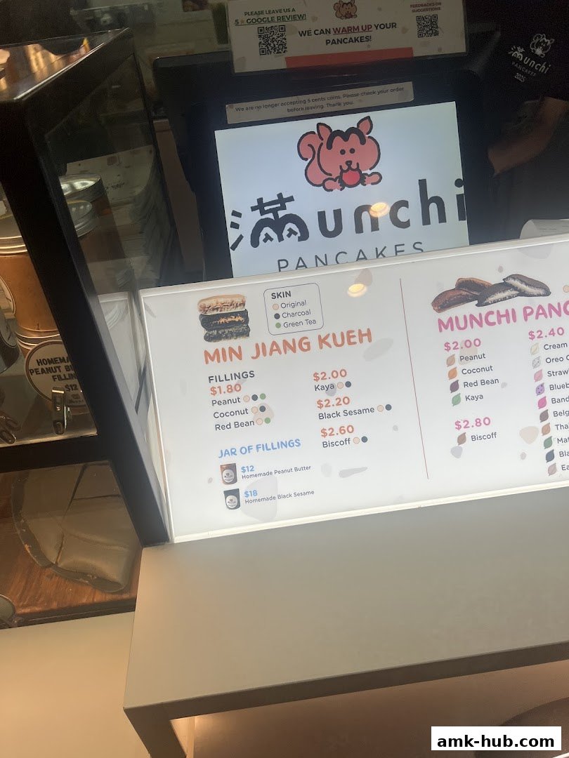 A menu board for Munchi Pancakes displaying various pancake fillings and flavors.
