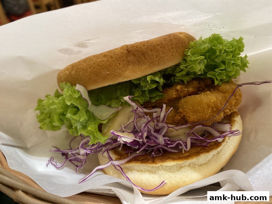 A close-up shot of a delicious MOS Burger with fresh lettuce and crispy chicken.