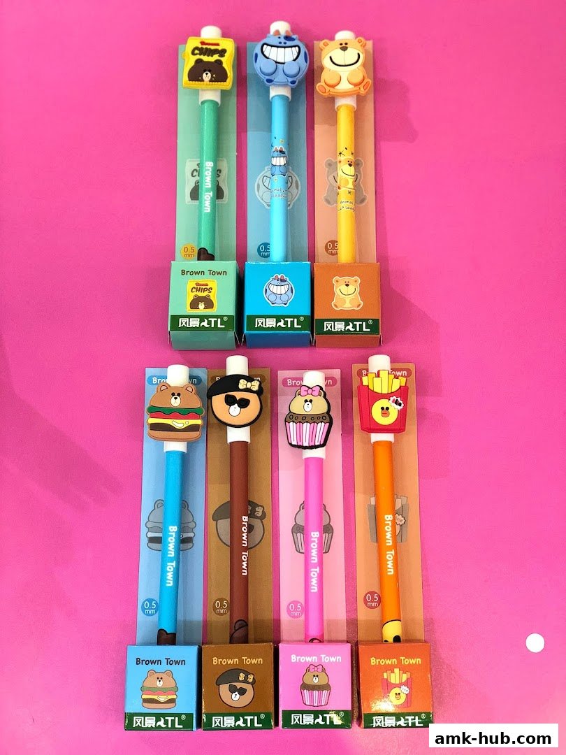 A collection of cute, novelty pens with cartoon character designs, including food and animal themes.
