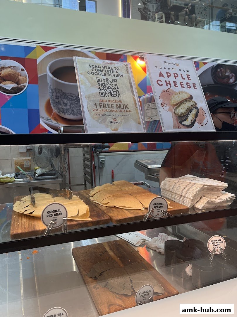 Display case with various pancake flavors and a sign for a Google review promotion.