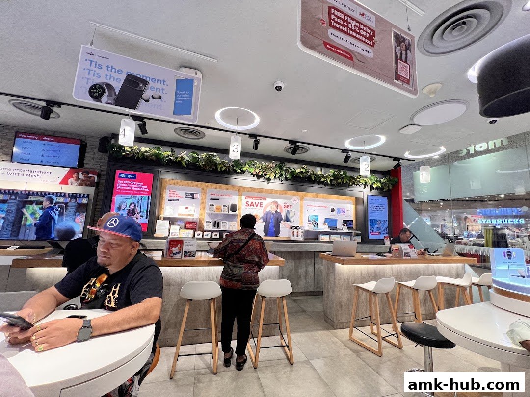 Interior of a Singtel shop with customers and displays of phones and accessories.