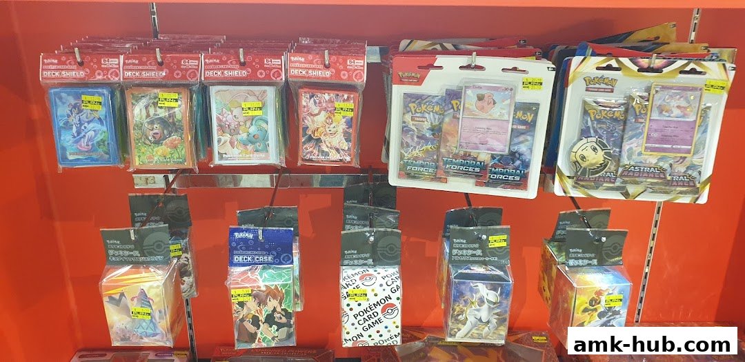 A display of various Pokémon trading card game accessories, including deck shields and card cases.
