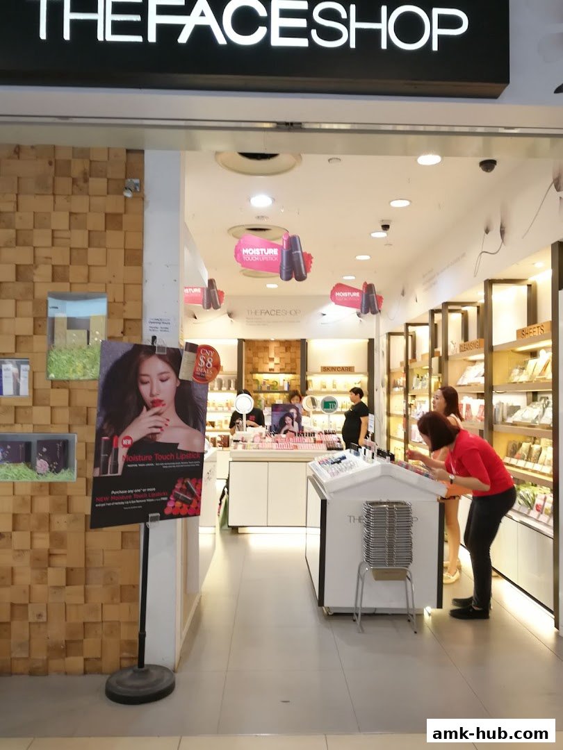 The entrance of THEFACESHOP, a beauty store, with promotional displays and products visible inside.