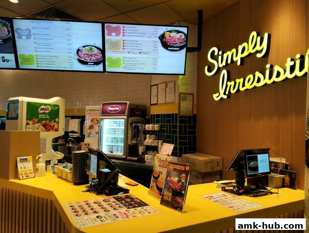 A bright yellow counter with digital menus displaying food items and a neon sign saying 'Simply Irresistible'.