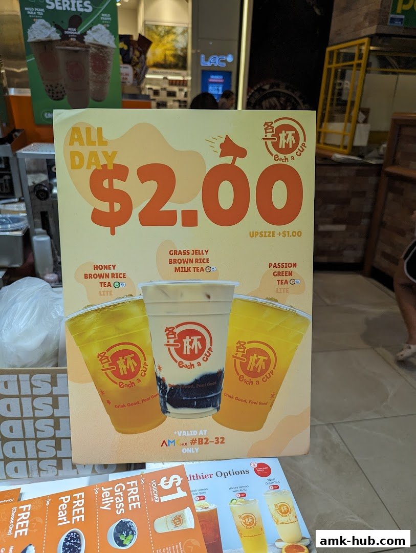 A promotional poster for 'Each A Cup' featuring drinks and a $2.00 special offer.