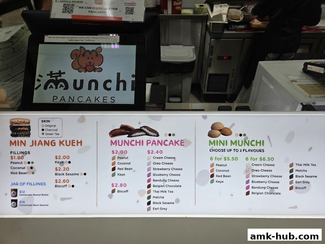 A menu board for Munchi Pancakes displaying various pancake options and fillings.
