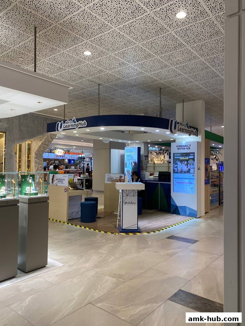 A modern booth for NTUC LearningHub with informational displays and seating.