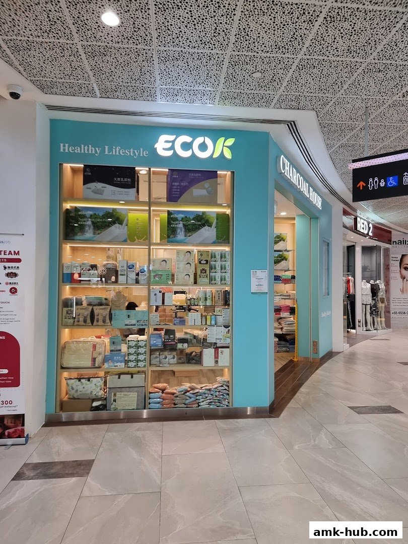 The ECOK Charcoal House shop front displays various health and lifestyle products on shelves.
