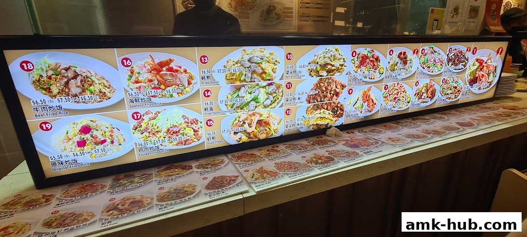 A brightly lit menu board displaying various Asian dishes with appetizing photos and prices.