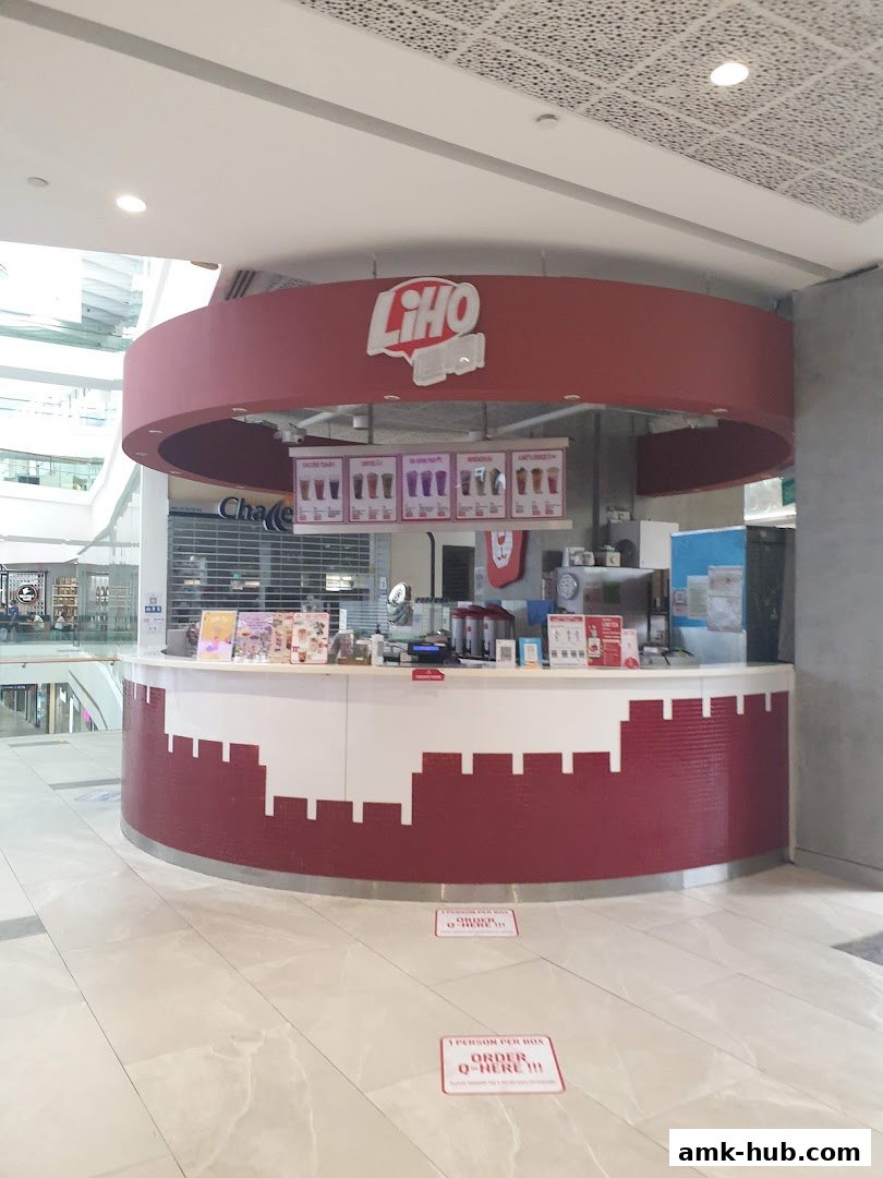 The LiHO TEA shop front with its signature red and white counter and branding.
