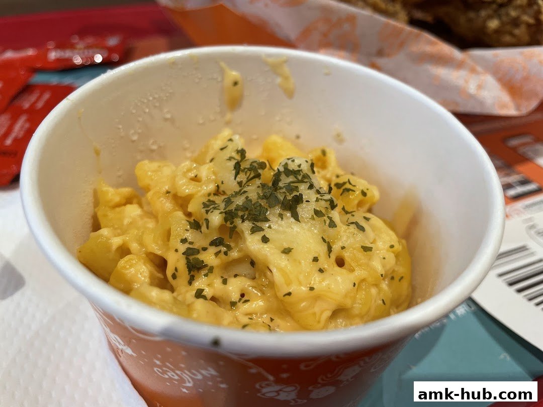 A close-up of Popeyes' creamy macaroni and cheese, topped with herbs.