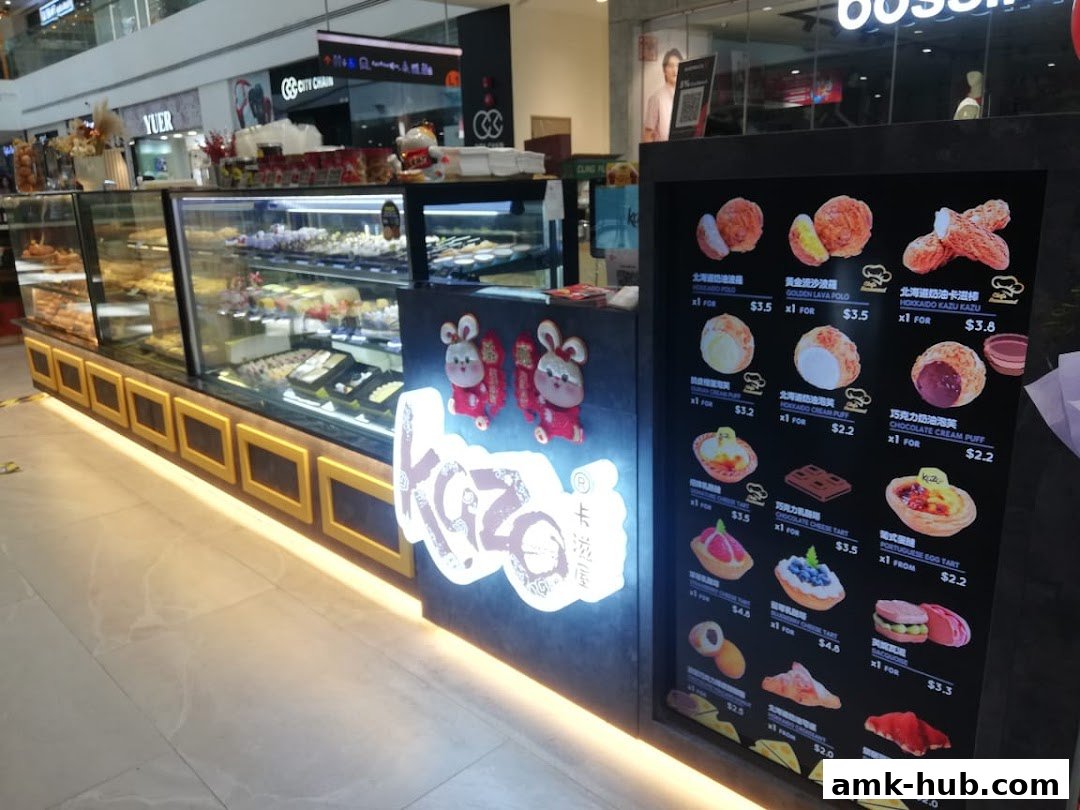 A display case filled with pastries and a digital menu board showing various sweet treats.