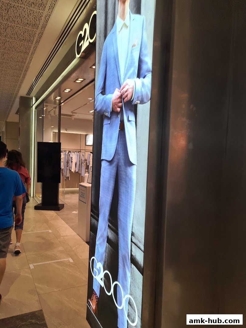 G2000 shop front with a digital display showing a man in a blue suit.