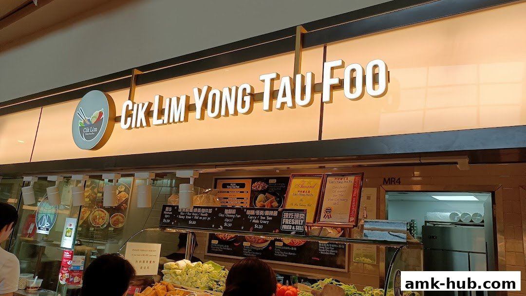 The storefront of Cik Lim Yong Tau Foo, featuring a prominent sign and display of food items.