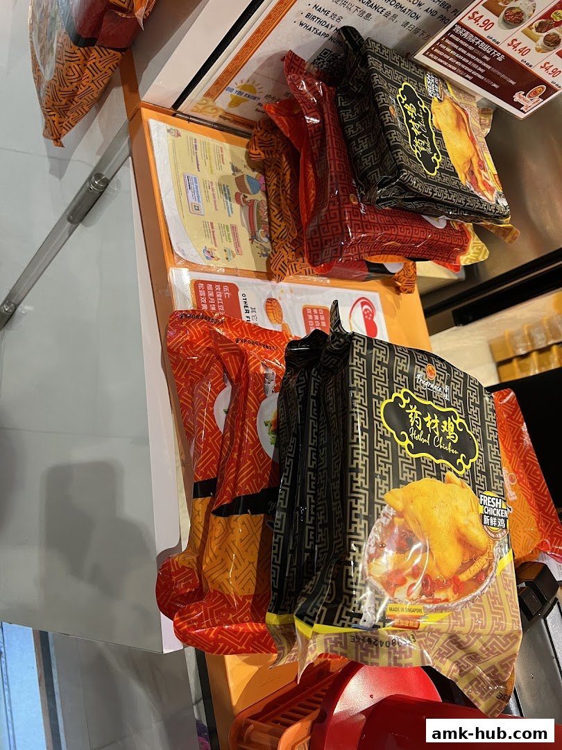 Packaged food items, including chicken and mooncakes, displayed in a retail setting.