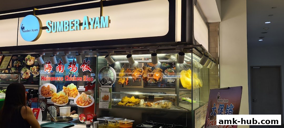 Sumber Ayam shop front displaying roasted chickens and Hainanese chicken rice dishes.