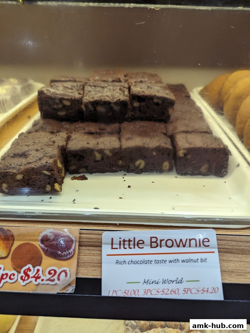 A display of freshly baked brownies with walnuts and a price label.