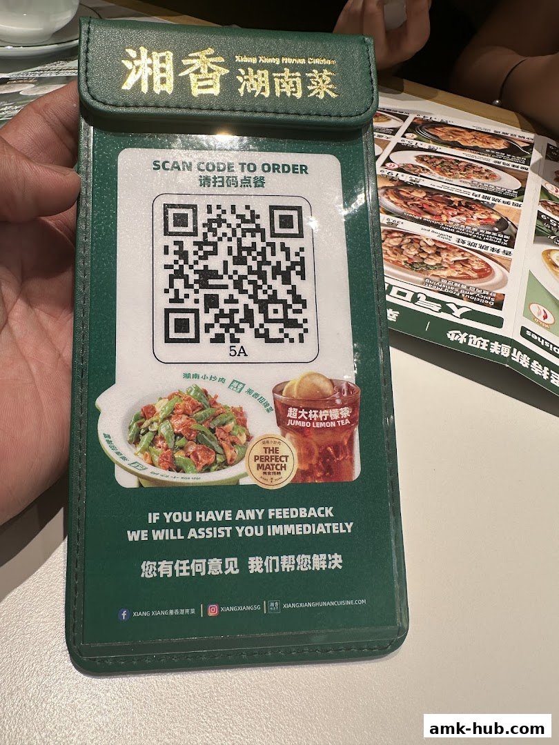 A menu holder with a QR code for ordering and images of food and drinks.