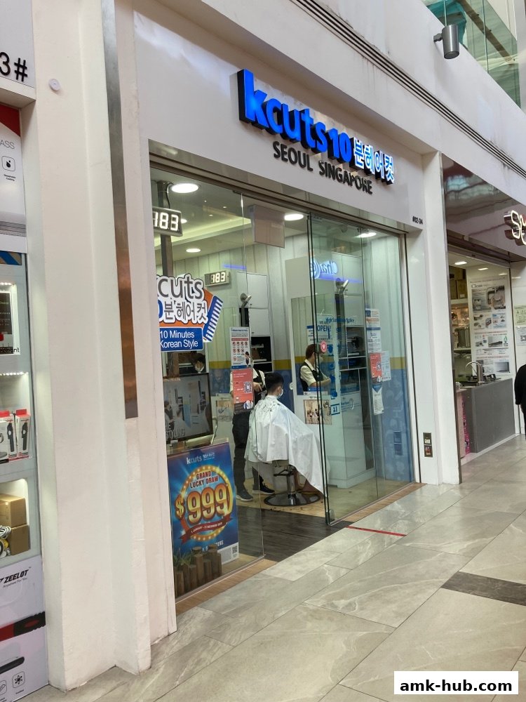 The exterior of a kcuts hair salon with a customer getting a haircut inside.