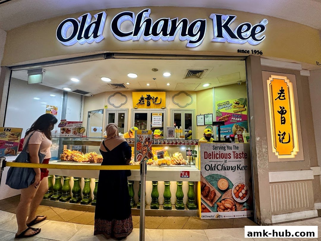 Old Chang Kee shop front with customers ordering food.