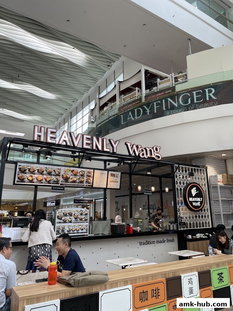 The Heavenly Wang shop front with a menu display and customers ordering food.