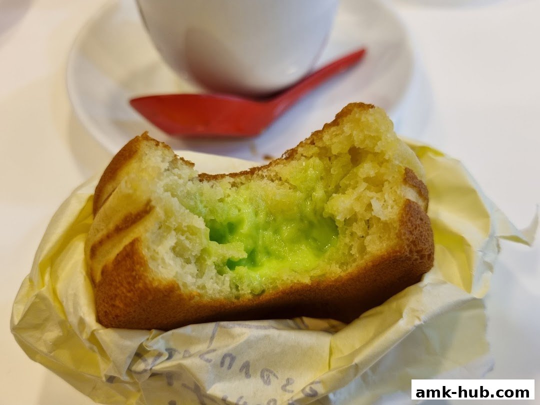 A close-up of a delicious-looking pastry with a bright green filling.