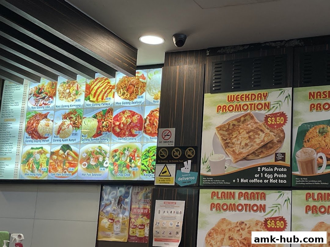 A menu board displaying various dishes and promotions for Prata Raya.