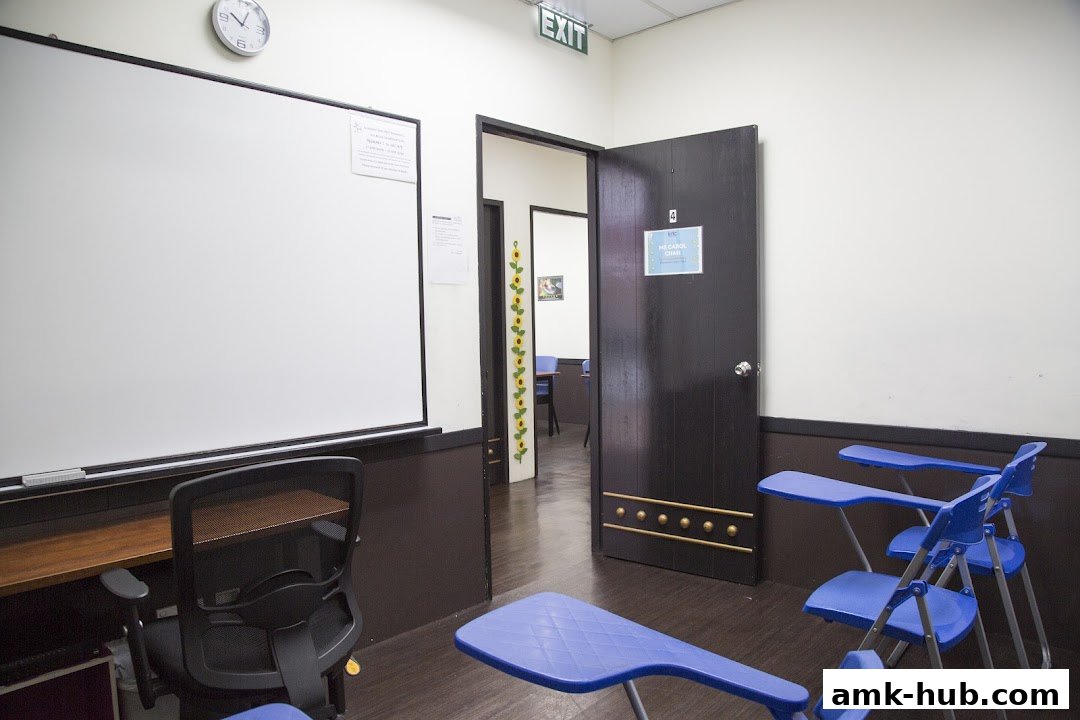 A classroom setting with a whiteboard, chairs, and an open door revealing another room.