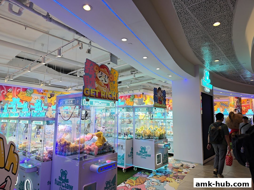 Interior view of a brightly lit claw machine arcade with plush toys and colorful decorations.