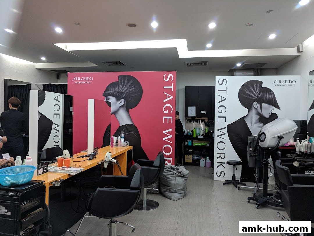 Interior of a modern hair salon with styling stations and large Shiseido professional hair art displays.