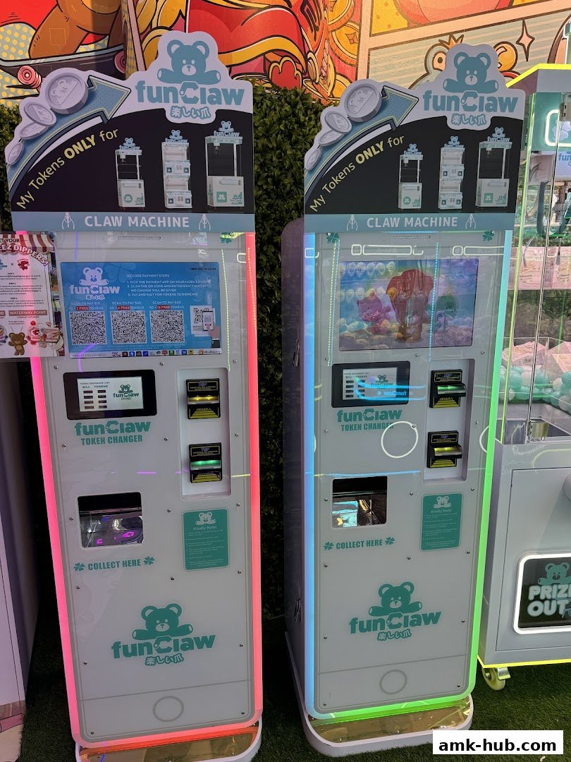 Two Fun Claw token changer machines and a claw machine with prizes are displayed.